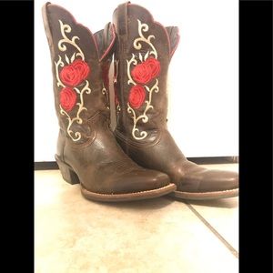 Ariat brown leather boots with stitched rose accents.